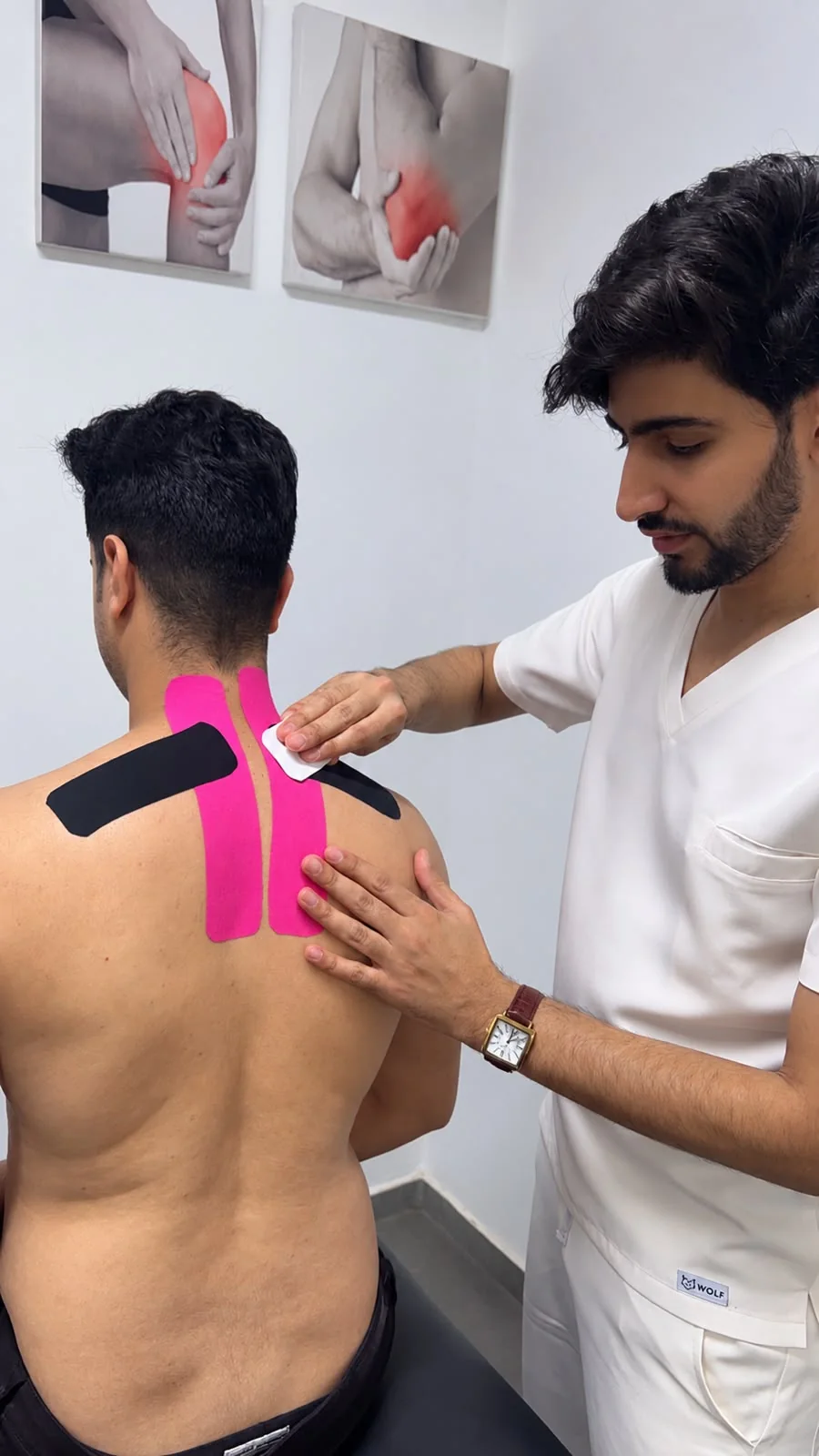 Abdellatif Edlaoui appliquant des bandes colorées sur le dos chez PhysioFlex